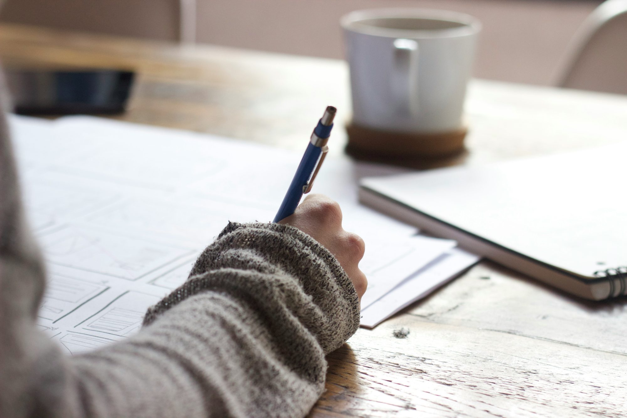 Content Creator in Moray writing down small business social media strategies